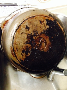 The difference on the pot after the first round, halfway cleaned.